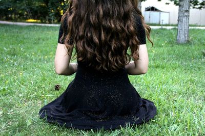 Woman standing on grassy field