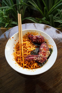 Korean hot spicy fried chicken served with ramen instant noodles, stir fried noodle.