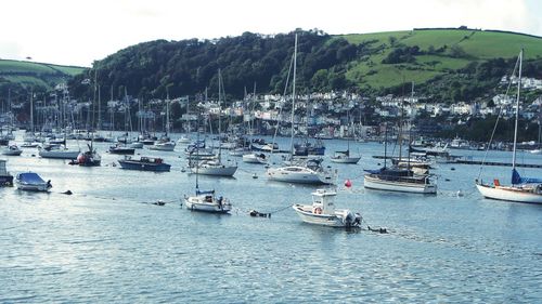 Boats moored in sea against sky