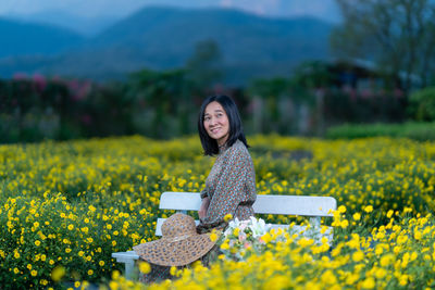 Portrait of a smiling young woman on field