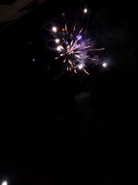 Low angle view of firework display at night