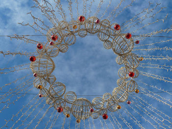 Low angle view of christmas decoration against blue sky