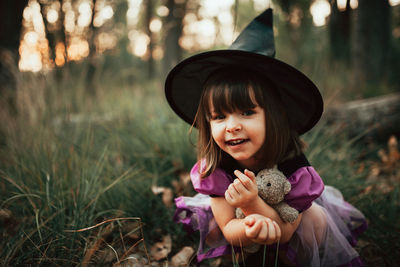 Cute girl holding toy on field