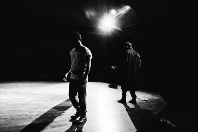 Rear view of people walking on stage
