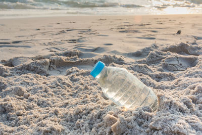 High angle view of water bottle at beach