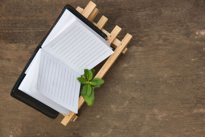 High angle view of book on wood