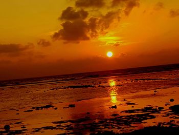 Scenic view of sea against orange sky