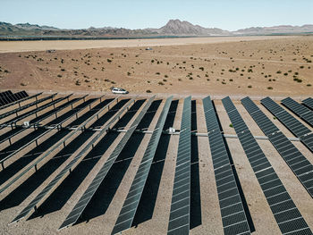  a massive solar farm of solar panels generating energy to power a city. two similar process with two 