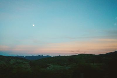 Scenic view of silhouette mountains against sky at sunset