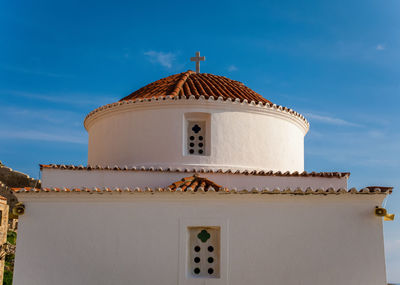 Low angle view of christian church against sky