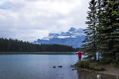 Scenic view of lake by mountains against sky