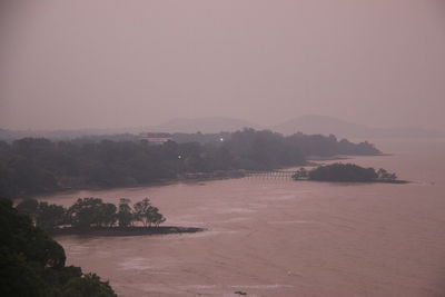 Scenic view of landscape against sky during foggy weather