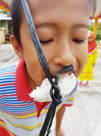 Close-up of boy eating food during game at playground