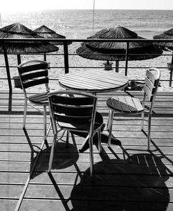 Empty chairs and tables on beach