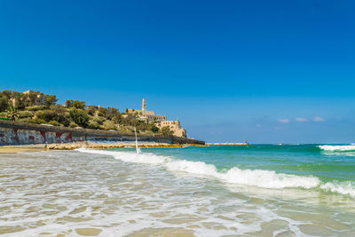 Scenic view of sea against clear blue sky