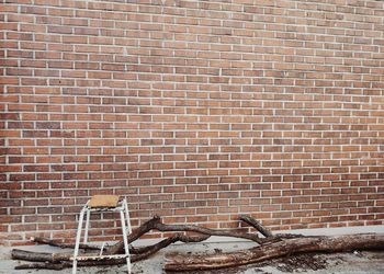 Rusty metal against brick wall