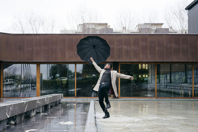 Man with umbrella walking in rain