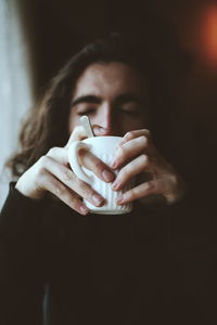 Portrait of woman holding coffee cup