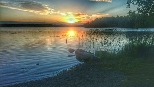 Scenic view of lake at sunset