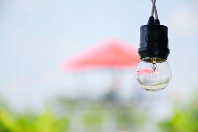 Low angle view of light bulb against sky