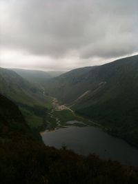 Scenic view of dramatic landscape against cloudy sky