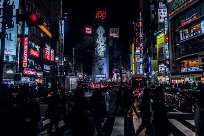 People walking on city street at night