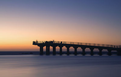 View of bridge at calm sea