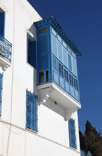 Low angle view of buildings against clear blue sky