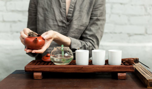 Midsection of woman making herbal medicine