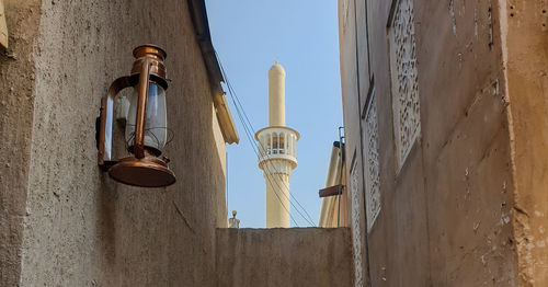 Low angle view of street light against building