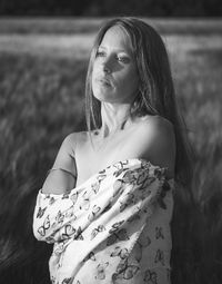 Thoughtful woman standing on field