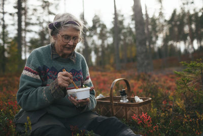 Senior woman having picnic