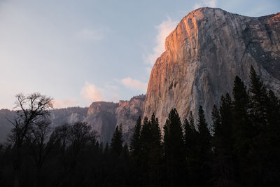 Soft sunset light illuminates the granite rock formations of yosemite