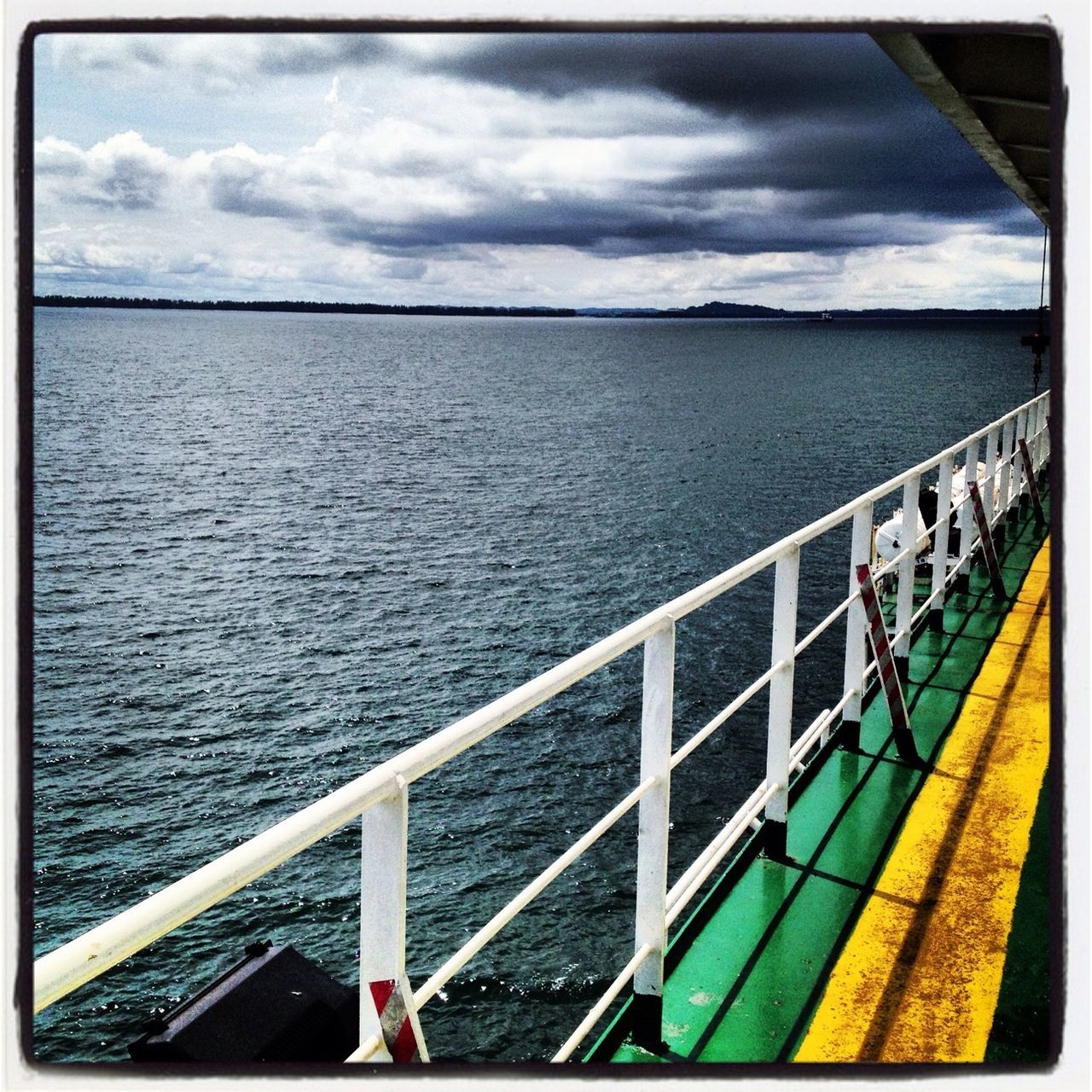 water, sea, railing, sky, transportation, cloud - sky, transfer print, mode of transport, horizon over water, cloud, nature, auto post production filter, nautical vessel, high angle view, day, scenics, tranquil scene, cloudy, beauty in nature, travel