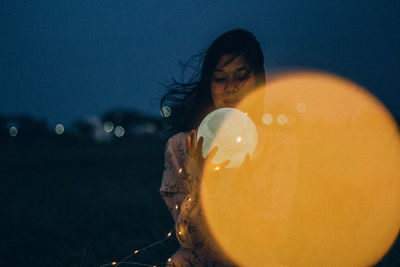 Portrait of woman with toy in water