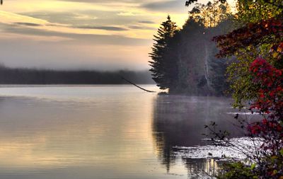 Scenic view of lake against sky at sunset