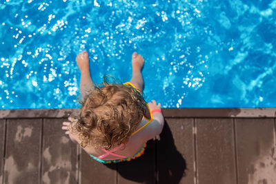 High angle view of boy playing in pool