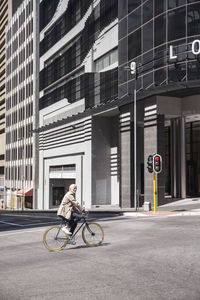 Mature man riding bicycle in the city