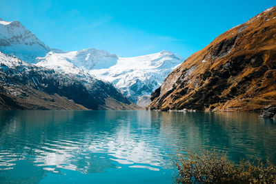 Scenic view of lake and mountains against sky