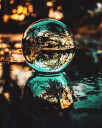 Close-up of crystal ball on wet footpath