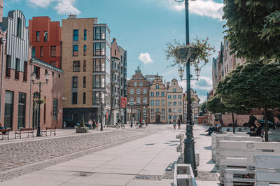 Street amidst buildings in city against sky