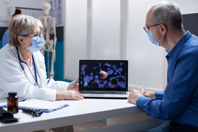 Side view of doctor working in office