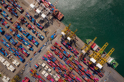 Container ship loading and unloading in sea port, aerial view of business logistic import 