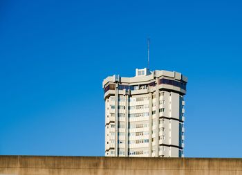 Low angle view of building against clear blue sky