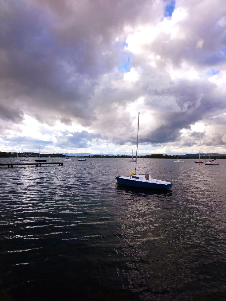 SCENIC VIEW OF SAILBOATS MOORED ON SEA AGAINST SKY