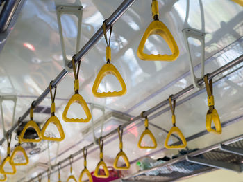 Low angle view of yellow lights hanging from ceiling