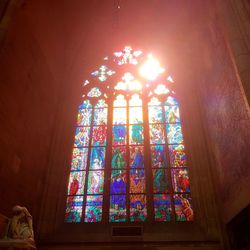 Low angle view of illuminated glass window in building