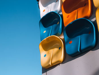 Low angle view of colorful wall against clear blue sky