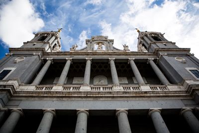 Low angle view of building against cloudy sky