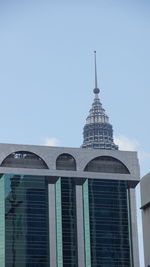 Low angle view of modern building against clear blue sky